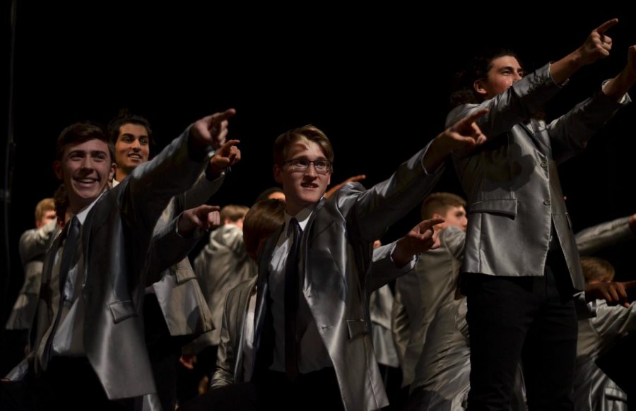 Zach Ring '18 (left), Jonah Marcussen '18 (center) and Sam Sunderland '19 (right) pose at the end of the guys' song, on Dec. 9 at Hancher.