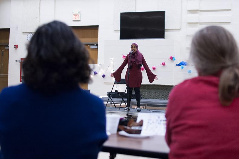 Khlood Saeed 20 performs her slam poetry piece at the Girl Up fundraiser on Dec. 8 in the cafeteria. 