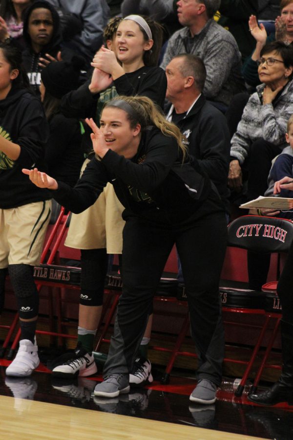 Bri Faulkner '18 claps after West scored a three pointer on Tuesday, Dec. 12.