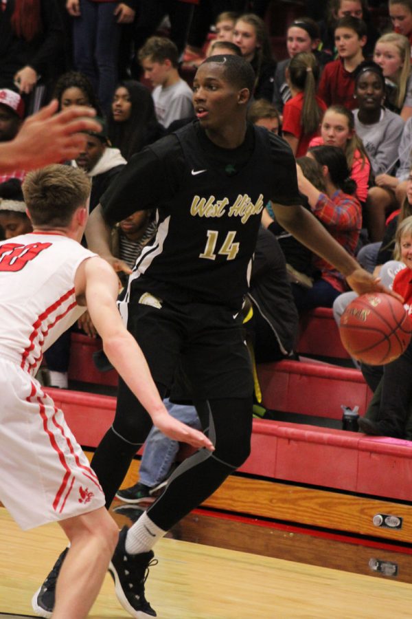 Hakeem Odunsi '18 protects the ball from a City player on Tuesday, Dec. 12.