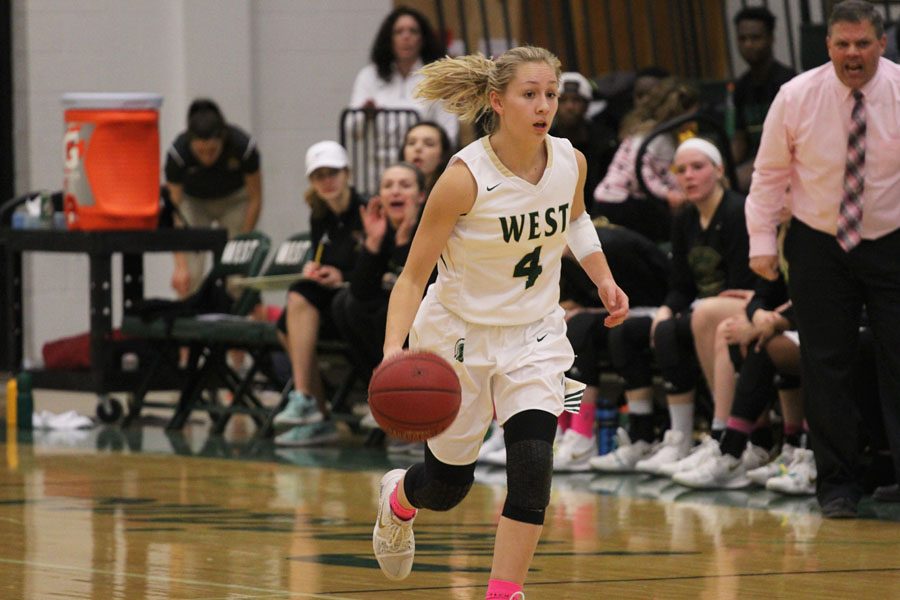 Point guard Lauren Zacharias '19 dribbles the ball as head coach BJ Mayer yells down the court what play to run next on Friday, Jan. 19.