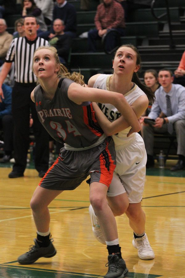 Paige Beckner '18 tries to get around Prairie's Halle Person '18 during a Trojan free throw in the first half of the game on Friday, Jan. 19.