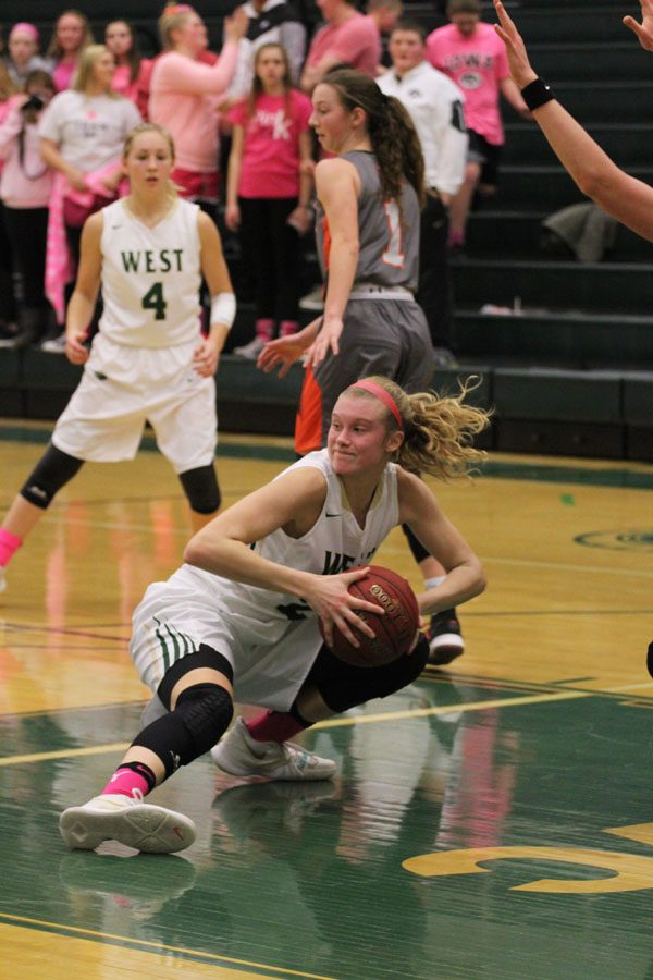 Emma Koch '19 tries to find a Trojan to pass the ball to as she slips on the court on Friday, Jan. 19.