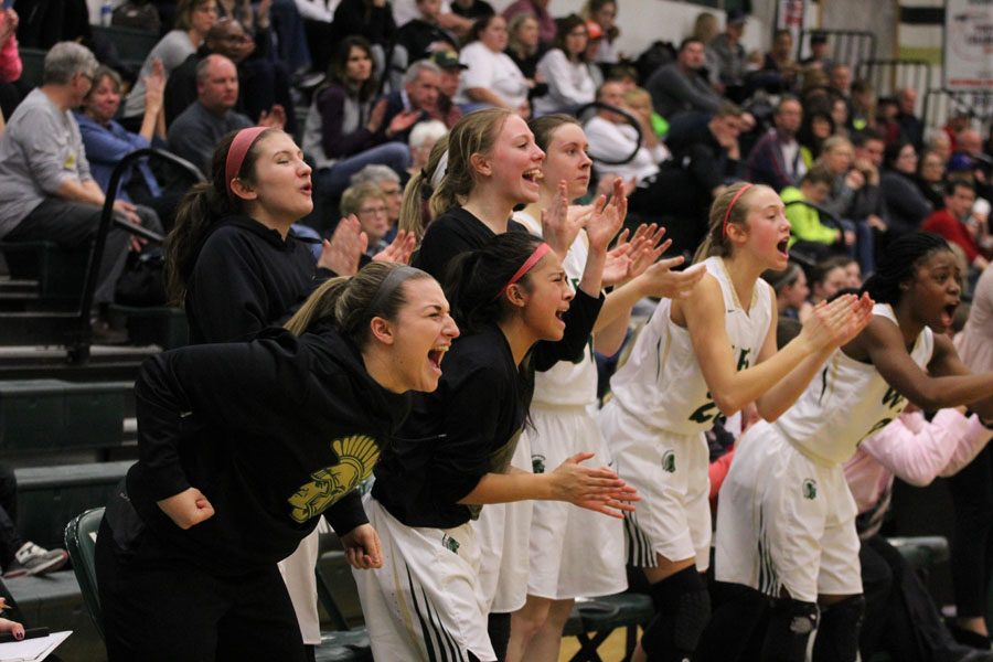 The team reacts in celebration after Lauren Zacharias 19 increased the lead for the Trojans to 49-34 on Friday, Jan. 19.