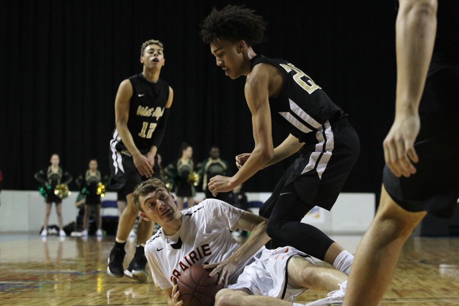 Dadrian Hoambrecker '18 goes after the ball as a Prairie player protects it during the first half of the game on Saturday, Jan. 20.