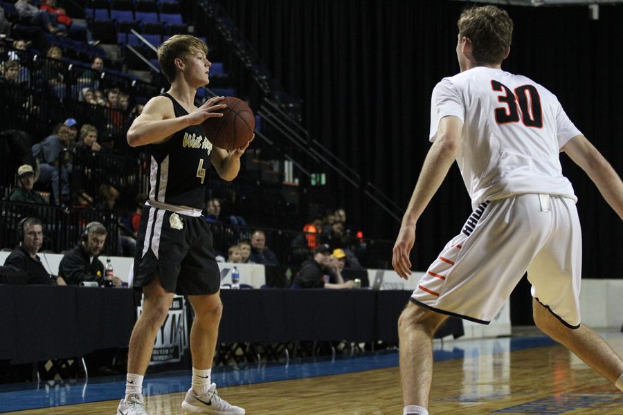 Evan Flitz '18 holds the ball away from Prairie's Harrison Cook '19 as he looks for a pass during the first half of the game on Saturday, Jan. 20.