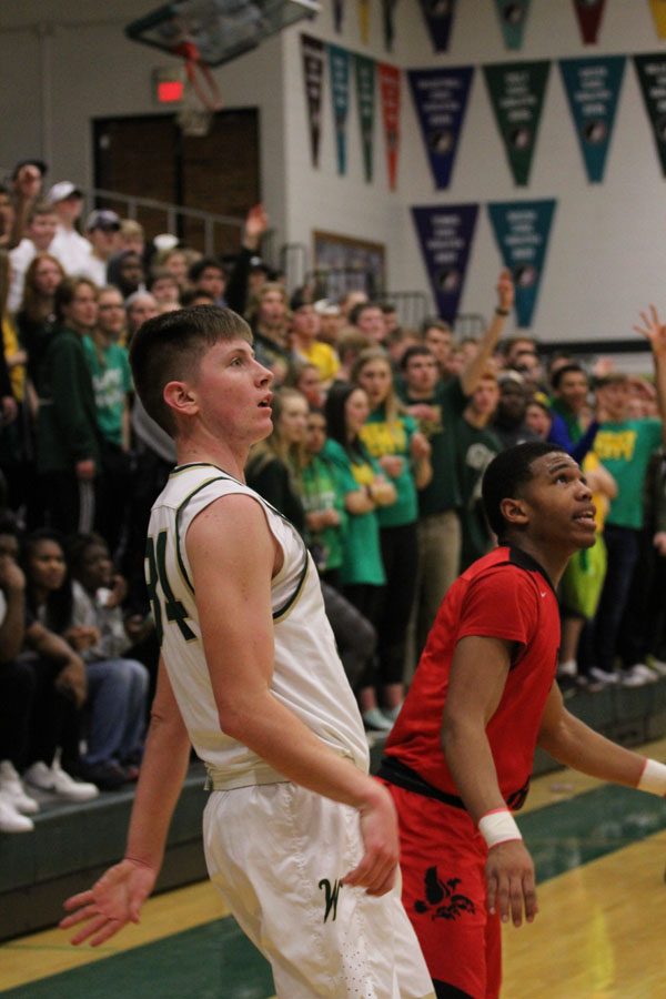 Jayson Barnes '18 shoots a 3-pointer at the last second to finish out the first half on Tuesday, Jan. 23. 