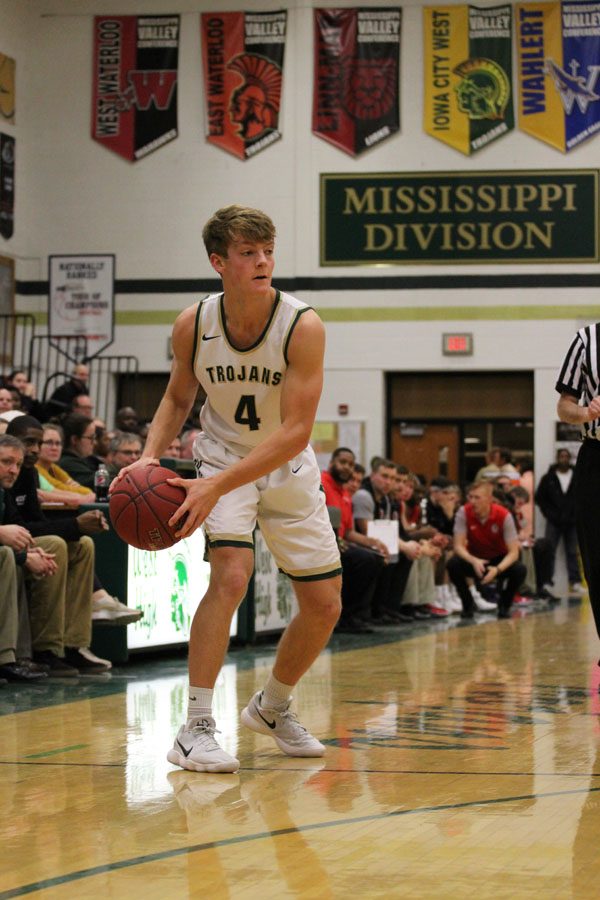 Evan Flitz '18 holds the ball away from City defenders as he looks to pass the ball on Tuesday, Jan. 23.