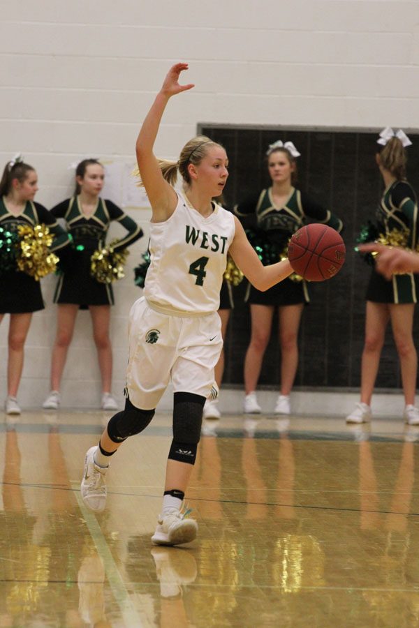 Lauren Zacharias ‘19 holds up "C" to show the offense what play to run during the first quarter on Friday, Jan. 26.