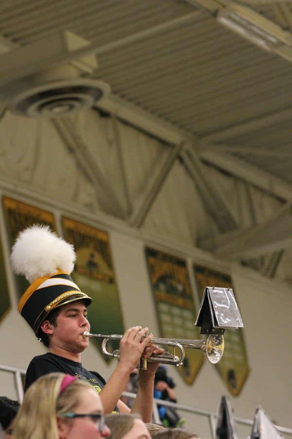 Devin Nolte '18 plays the trumpet during the break between the first and second quarter on Tuesday, Jan. 30.