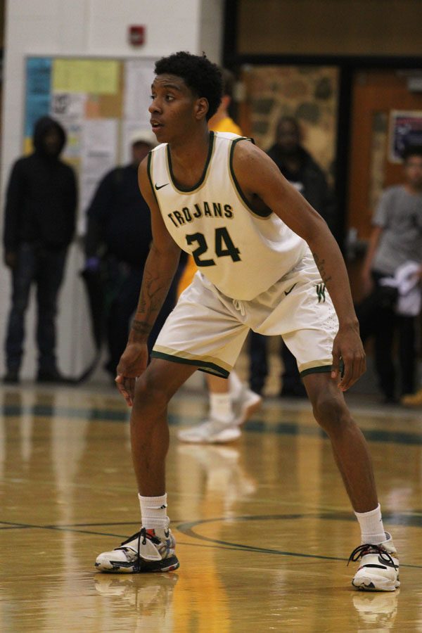 Paul McGee '18 waits for Kennedy's point guard to come down the court on Tuesday, Jan. 30.