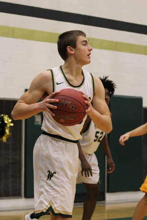 Cole Mabry '19 holds the ball away from a defender from Kennedy as he looks for a pass on Tuesday, Jan. 30.