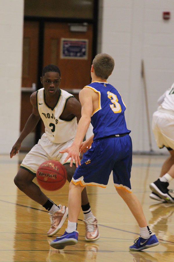 Dante Eldridge '18 guards Wahlert's Cael Schmitt '20 as Schmitt dribbles the ball up the court for Wahlert on Friday, Jan. 5.