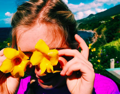 Author Fenna Semken posing with flowers on her recent vacation, yet another part of her life that she has found happiness in.