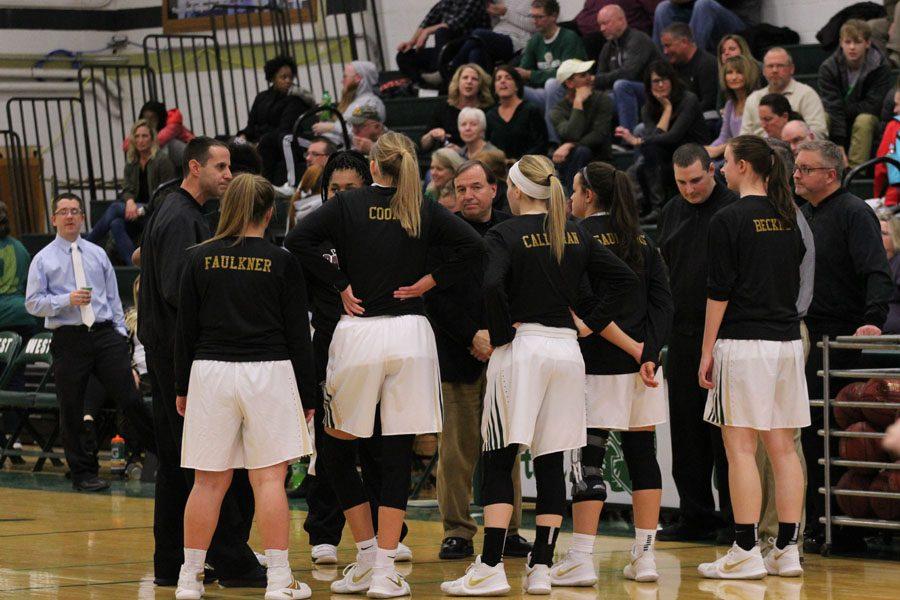 From left to right, seniors Brianna Faulkner '18, Logan Cook '18, Carrie Callahan '18, Rachael Saunders '18 and Paige Beckner '18 shake hands with Waterloo West's captains before the game on Friday, Feb. 9.