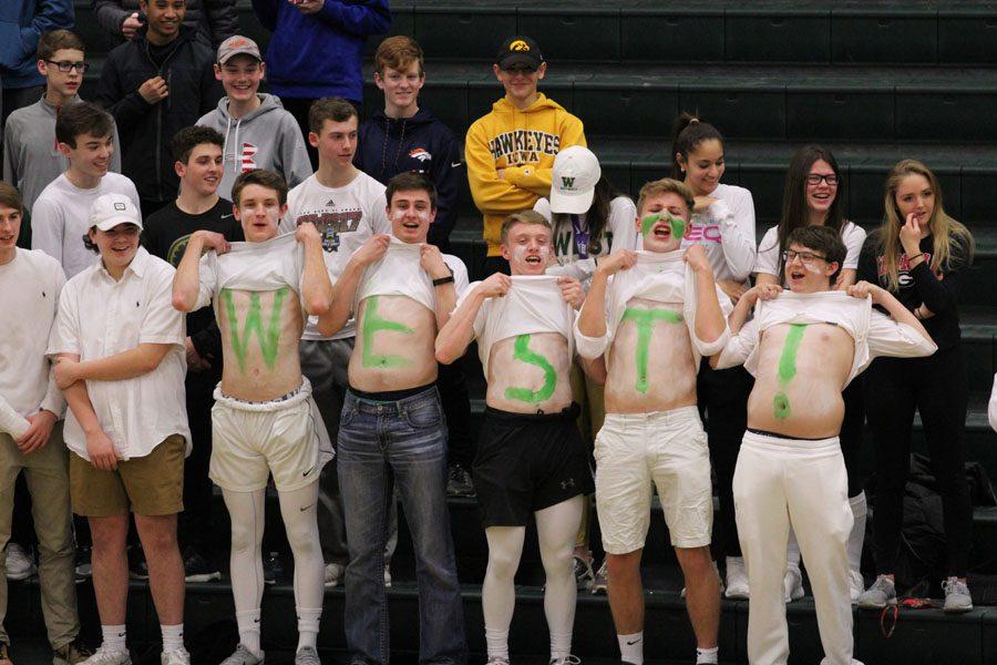 Students in the student section cheer on the Trojans during the first half of the game on Tuesday, Feb. 13.