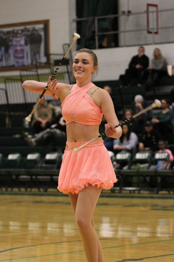 Arielle Comellas '18 twirls two  batons during her halftime performance with Lizzy Slade '21 on Tuesday, Feb. 13.