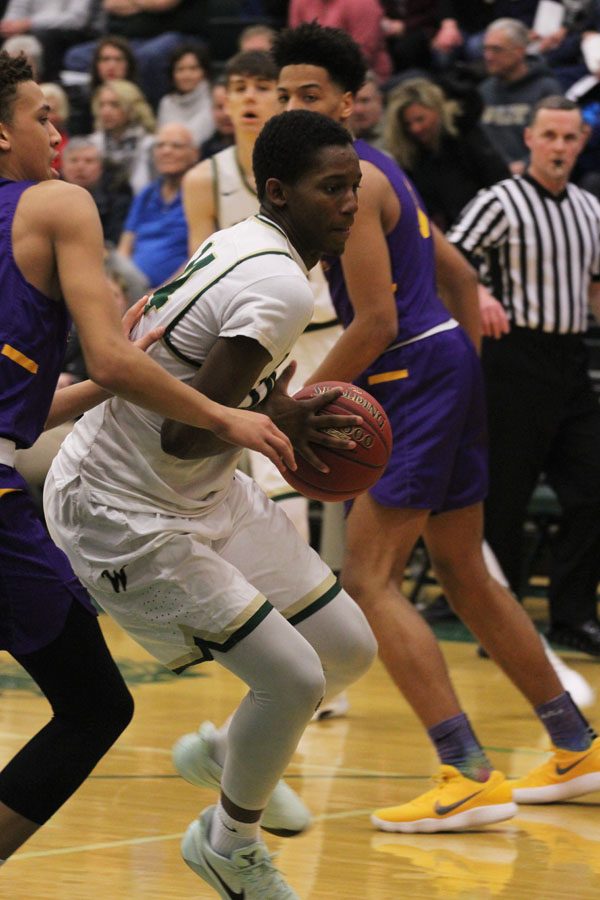 Hakeem Odunsi '18 tries to maneuver around Cretin-Derham's defense on Saturday, Feb. 17.