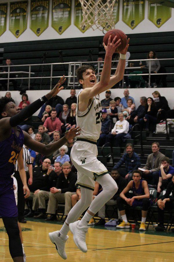 Patrick McCaffery '19 scores 2 points for the Trojans in the first half on Saturday, Feb. 17.