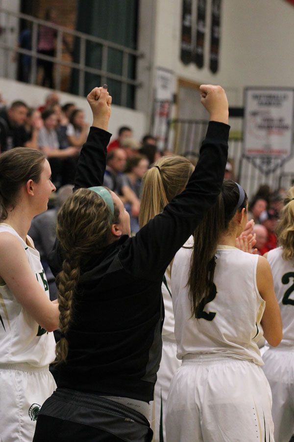 Bri Faulkner '18 pumps her fists up in the air after Grace Schneider '20 shot a three-pointer during the fourth quarter on Saturday, Feb. 17.