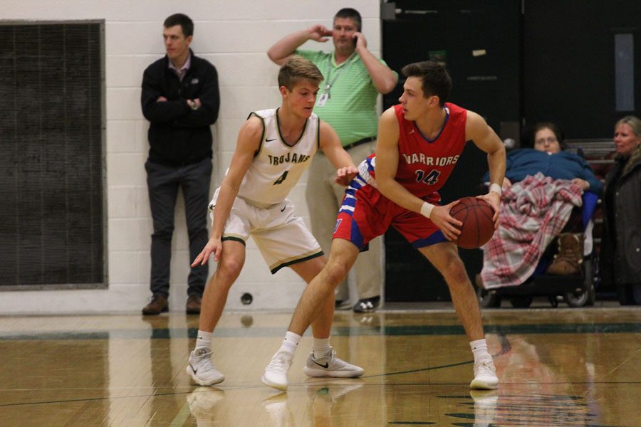 Evan Flitz '18 guards Cedar Rapids Washington's Drew Christensen '18 during the first quarter on Friday, Feb. 23.