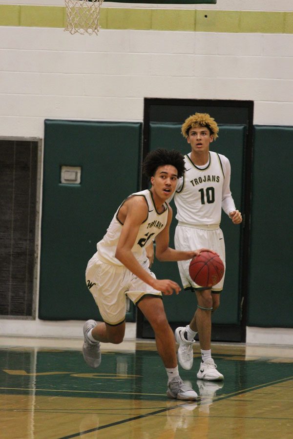 Dadrian Hoambrecker '18 tries to get the ball down the court in the last seconds of the first quarter on Friday, Feb. 23.