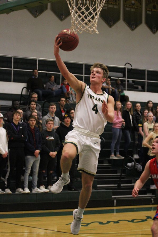 Evan Flitz '18 goes for a layup after he stole the ball from a Cedar Rapids Washington player during the first half on Friday, Feb. 23.