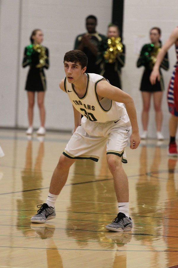 Brayden Adcock '19 gets ready to defend a player from Cedar Rapids Washington on Friday, Feb. 23.