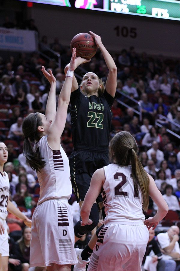 Logan Cook '18 takes a shot as two defenders from Dowling try to block her on Monday, Feb. 26.