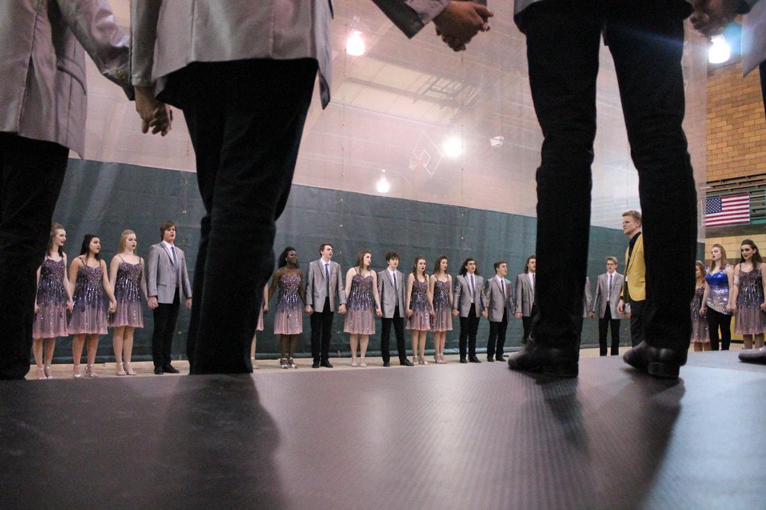 Good Time Company sing their ballad in a circle formation before going onstage at their first competition in Muscatine.
(Lauren Ernst)