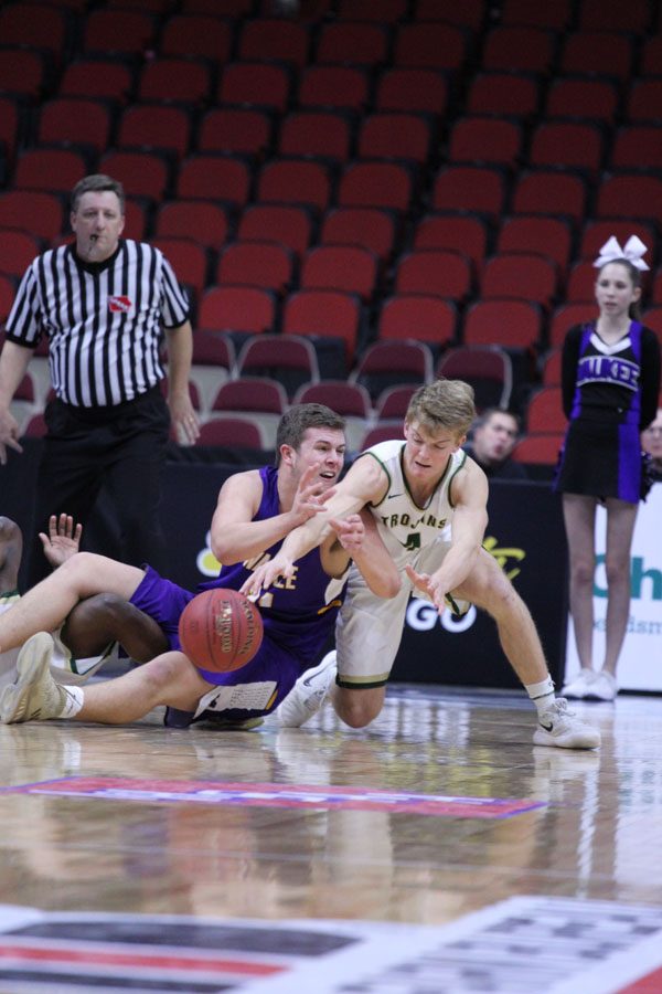 Evan Flitz '18 knocks the ball out of Waukee players hands on Thursday, March 8.