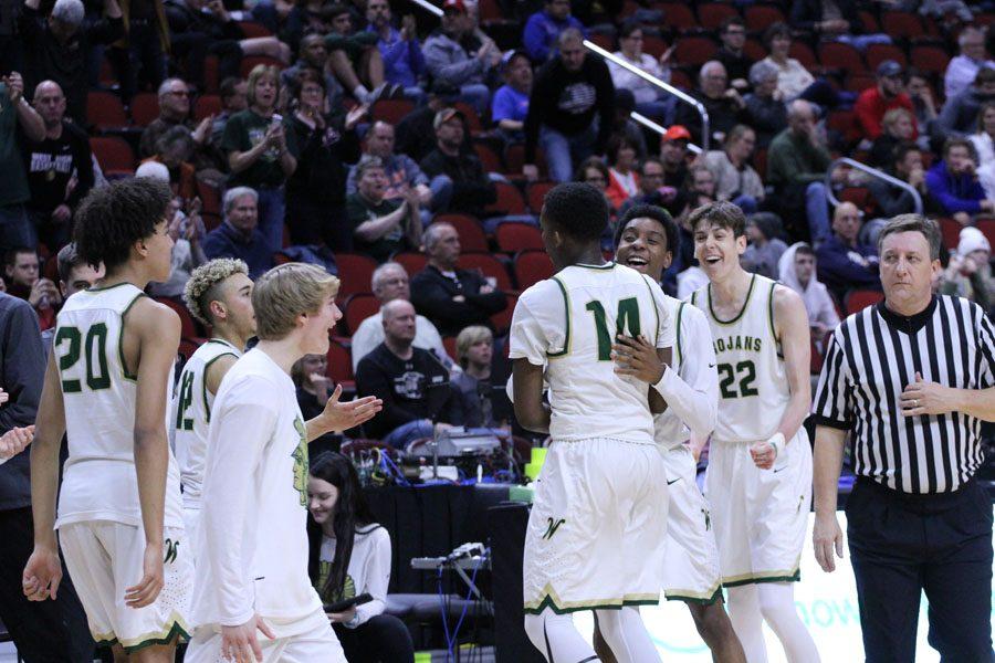 Paul McGee '18 hugs Hakeem Odunsi '18 after their win on Thursday, March 8.