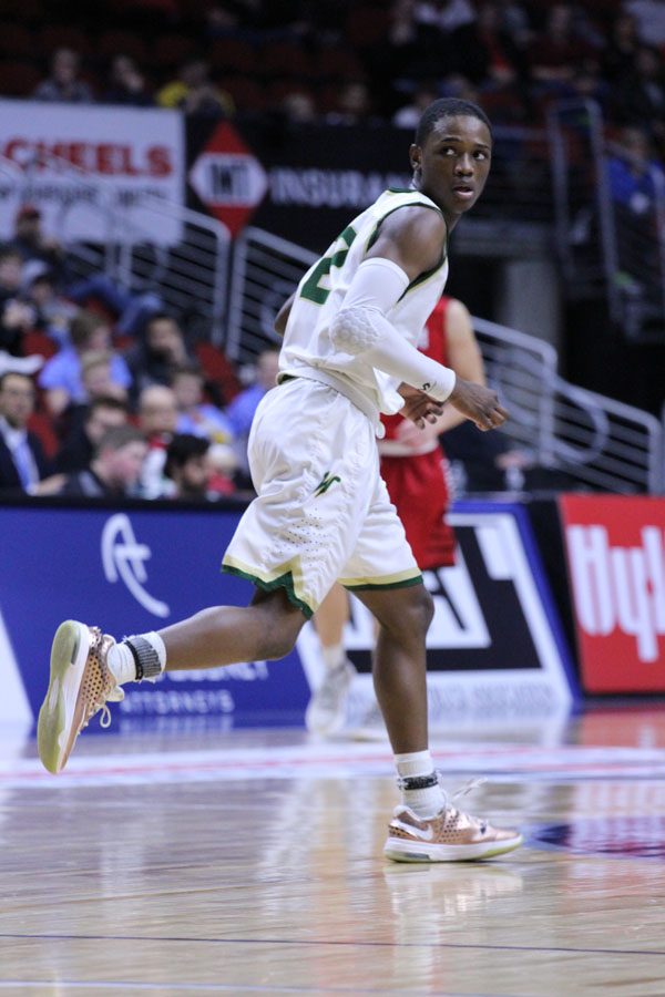 Dante Eldridge '19 runs back to defend Cedar Falls during the first half of the game on Friday, March 9.