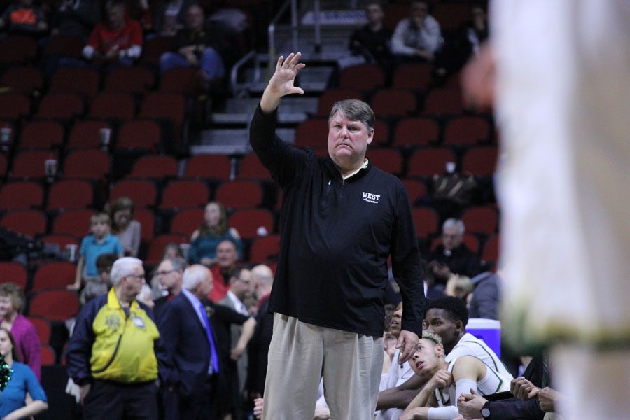 Coach Steve Bergman tells the Trojan offense what play to run during the first half of the game on Friday, March 9.