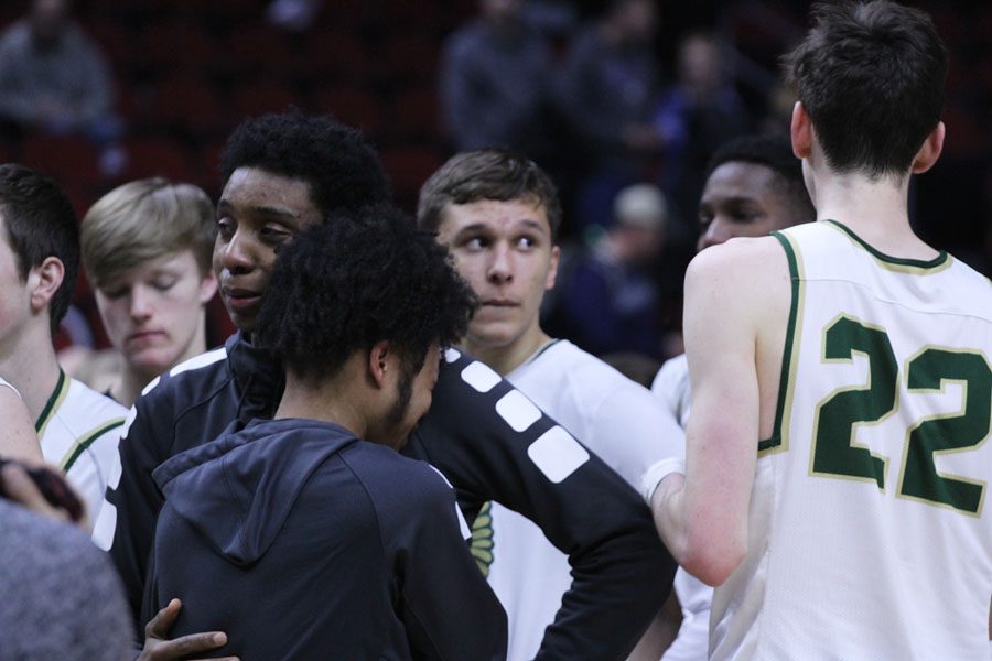 Riajad Lee '18 hugs Paul McGee '18 after their lose on Friday, March 9.