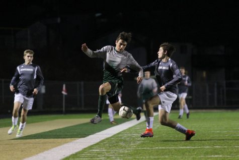 Micah Frisbie 20 jumps in the air as he tries to stop the ball on Friday, March 30.