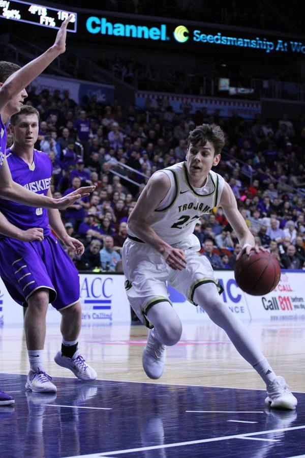 Patrick McCaffery ’19 dodges defenders from Muscatine during the first half of the game on Tues., March 6.