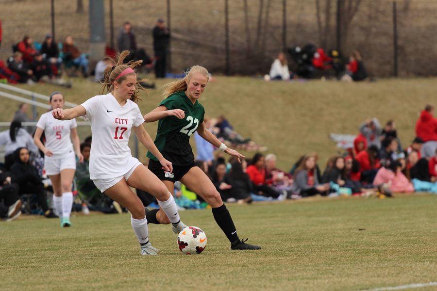 Lizzie Raley 18 and City Highs Callie Menzel 21 battle for the ball on Friday, April 20.
