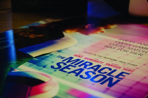 A poster for The Miracle Season sits on a table during a book signing. 