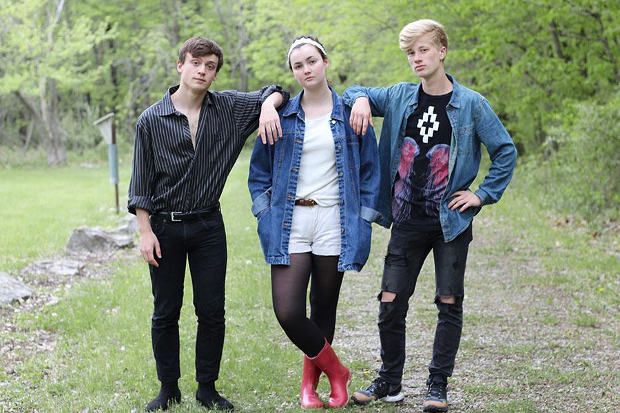 Seniors Nick Pryor, Alyson Kuennen and Ethan Goers stand together on a trail at Lake McBride on Saturday, May 12.
