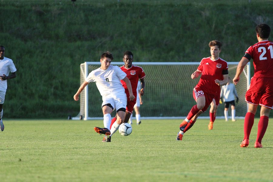 Micah Frisbie '20 kicks the ball up the field during the first half of the game on Tuesday, May 15.