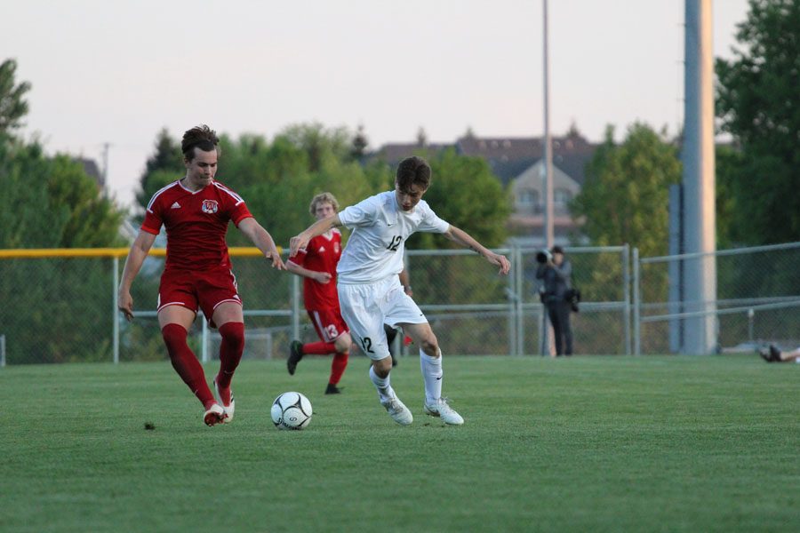 Kaiya Luethje '18 battles for the ball against Cedar Rapids Washington's Bennett Cooper '19 on Tuesday, May 15.