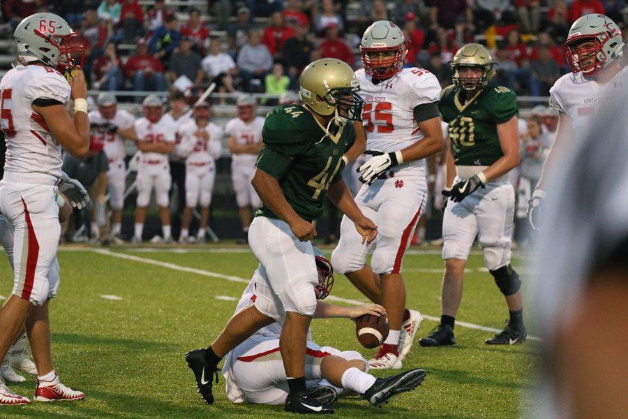 Landon Green '19 celebrates after he tackled an offensive player from North Scott during the first half of the game on Friday, Aug. 24.