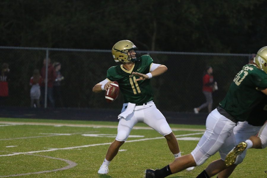 Joey Kuehn '19 throws a long touchdown pass to Jalen Gaudet '19 during the first half of the game on Friday, Aug. 24.