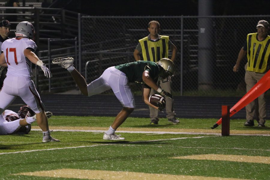 Jalen Gaudet '19 dives into the end zone to score a touchdown on Friday, Aug. 24.