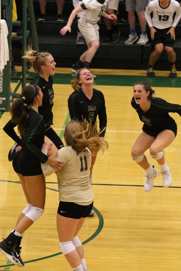 The teams celebrates after they defeated Liberty 28-26 in the first set on Tuesday, Aug. 28.