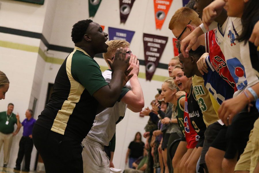 Keshawn Shaw '19 and Alex Geasland '19 lead cheers for the student section in between sets on Tuesday, Aug. 28.