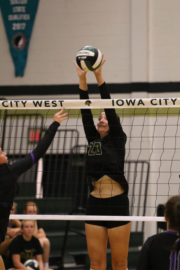 Ellie Kouba '19 jumps as she hits the ball during the third set on Tuesday, Aug. 28.