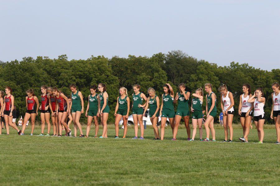 The varsity team lines up at the start line before the race on Thursday, Aug. 23.