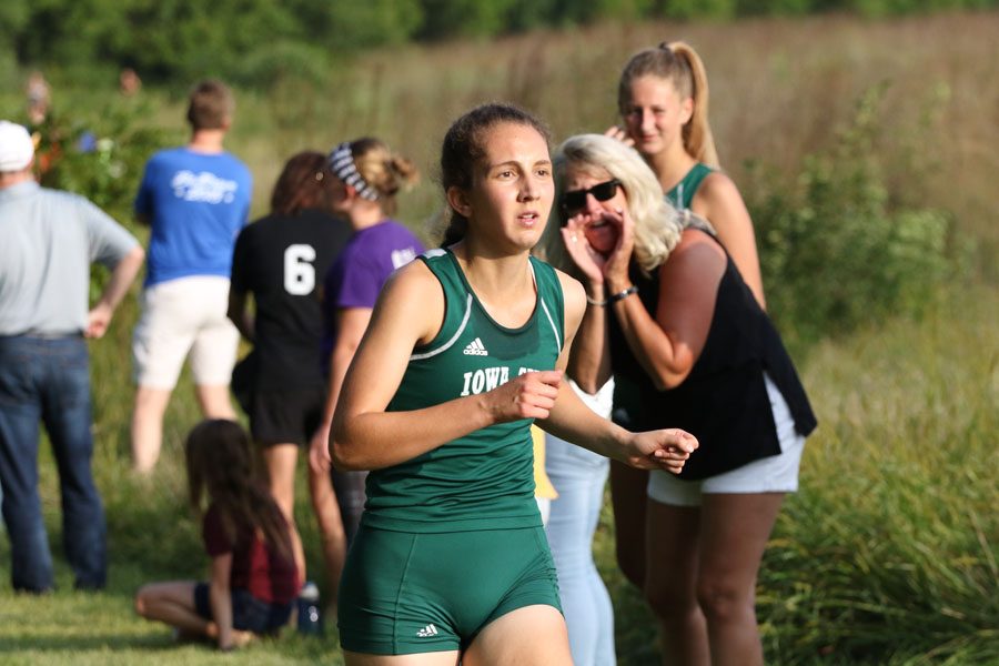 Deniz Ince '19 runs past the second mile marker on Thursday, Aug. 23.